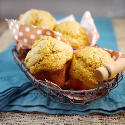 some muffins are in a basket on a table