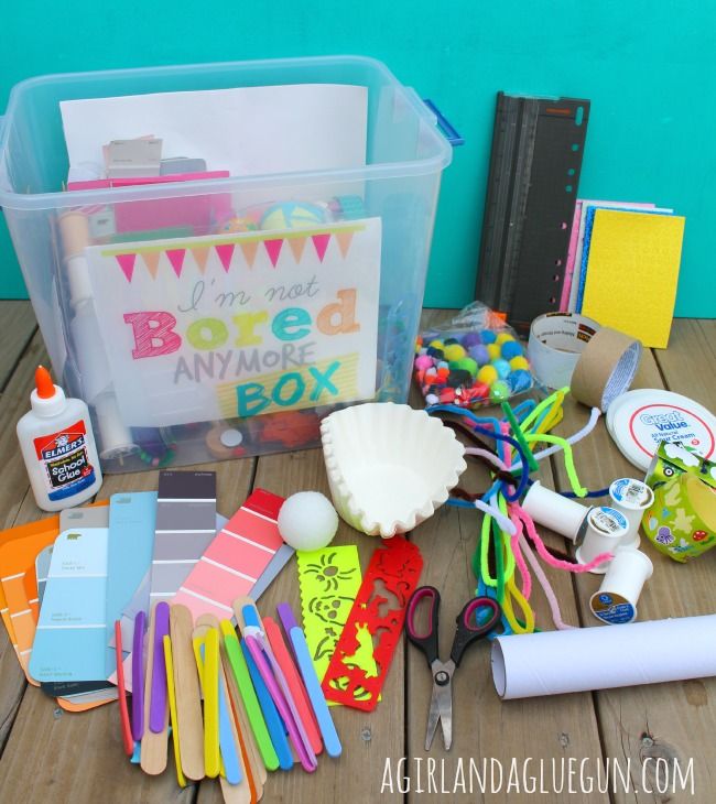 an assortment of crafting supplies on a wooden table next to a box with the words i'm not bored anymore