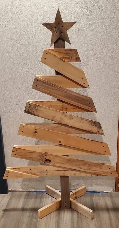 a wooden christmas tree made out of wood planks