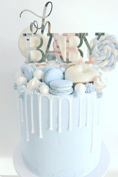 a blue and white cake with the words baby on it