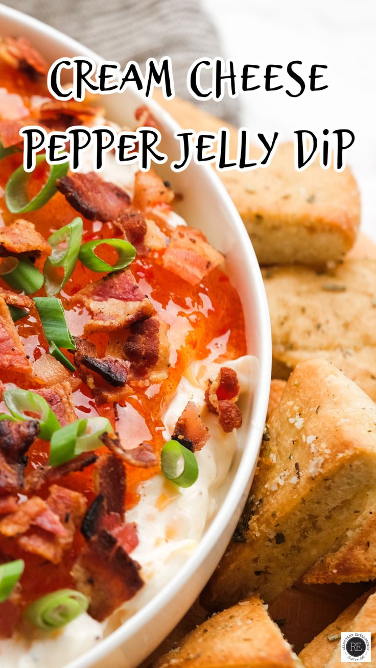 a white bowl filled with cream cheese and pepper jelly dip next to some crackers