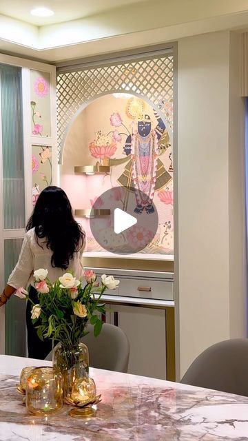 a woman standing in front of a table with flowers