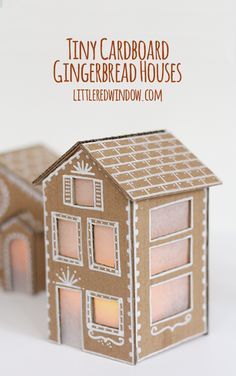 the tiny cardboard gingerbread house is lit up and ready to be used as a decoration