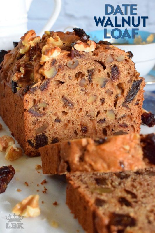 a loaf of bread with nuts and raisins sitting on a plate next to another loaf