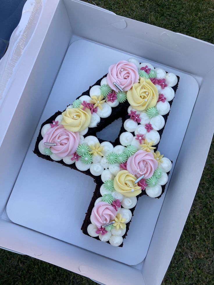 the number four cake is decorated with flowers