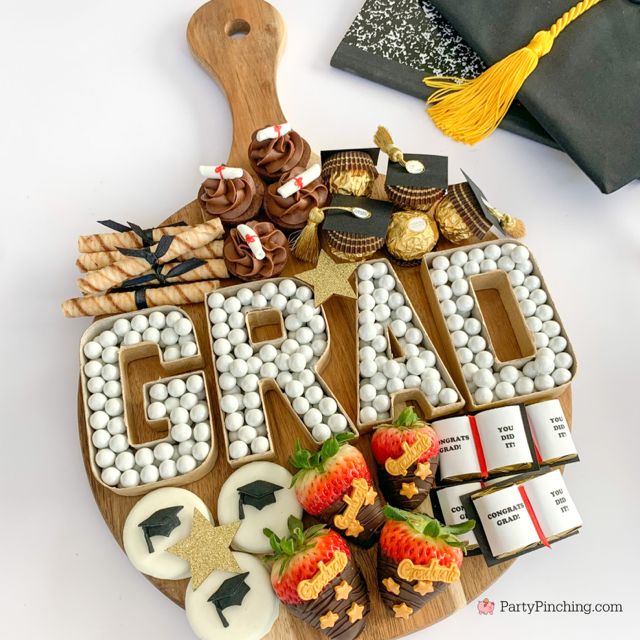 the word grad spelled out with chocolates and strawberries