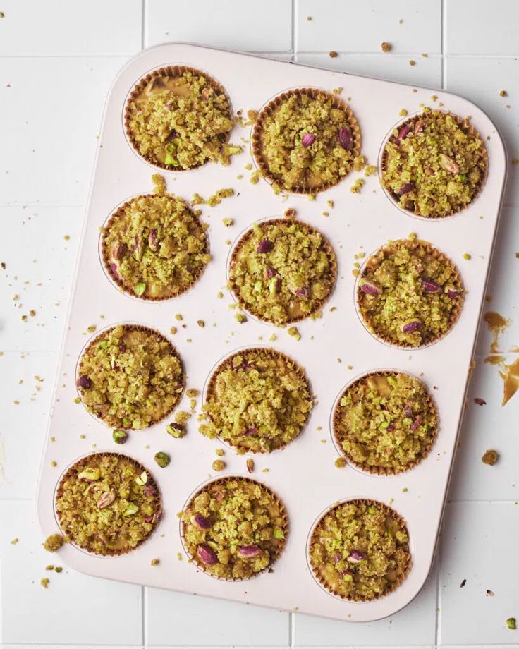 a muffin tray filled with lots of oatmeal and other toppings