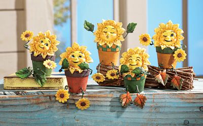 sunflowers are arranged in flower pots on a table