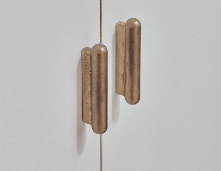 two pieces of wood are hanging on the wall