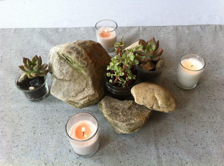 candles, rocks and succulents on a table