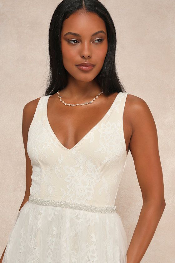 The Lulus Sweet Love Ivory Lace Beaded Maxi Dress is all about the glam and the glitz! Stunning floral lace overlays a beige knit liner as it shapes this elegant maxi dress with a V-neckline, a darted sleeveless bodice, and slender shoulder straps. A shiny beaded waist tops two layers of feminine tulle to give the elegant maxi dress a full silhouette. Hidden back zipper/clasp. Fit: This garment fits true to size. Length: Floor length. Size medium measures 60" from shoulder to hem. Bust: Works be Elegant Bridesmaid Lace Dress With Delicate Details, Elegant Beige Dress With Lace Top, Glamorous Lace Maxi Dress For Wedding, Cream Lace Maxi Dress For Party, Elegant Cream Dresses With Lace Top, Fitted Lace Top Maxi Dress For Wedding, Elegant Lace Maxi Dress For Bridesmaid, Fitted Maxi Dress With Lace Top For Wedding, Elegant Cream Dress With Lace Top