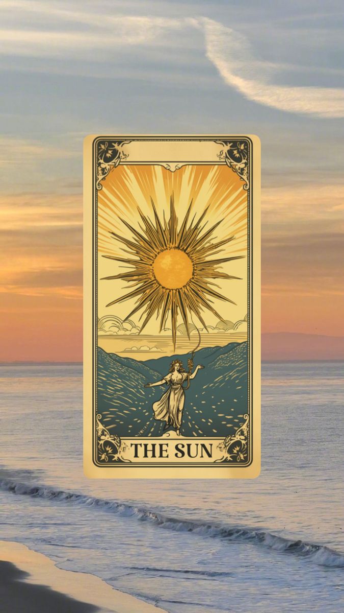 the sun tarot card sitting on top of a beach