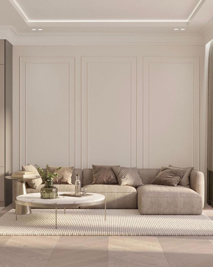 a modern living room with white walls and beige furniture