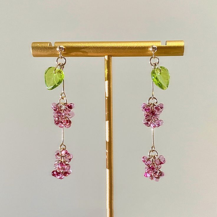 Are you looking to add a pop of color and artisan style to your accessory collection? These Bohemian glass bead earrings are just what you need. Handcrafted by skilled artisans using centuries-old Czech glasswork techniques, each pair features a unique cascade of colorful glass beads, shaped and painted to look like wildflowers, fruits, and vines. Don't you love how the handmade process results in one-of-a-kind designs? The beautiful thing about these handcrafted earrings is that they go with ev Czech Glass Flower Jewelry With Colorful Beads, Pink Beaded Czech Glass Earrings, Fruit Shapes, Multi-strand Czech Glass Colorful Beads Jewelry, Beaded Fruit, Flower-shaped Czech Glass Jewelry With Colorful Beads, Czech Glass Jewelry Artbeads.com, Unique Fruit, Jewelry Hooks