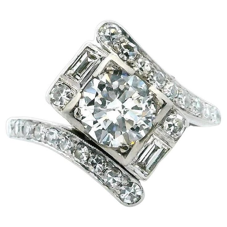 an engagement ring set with diamonds on the sides and two bands around it, in white gold