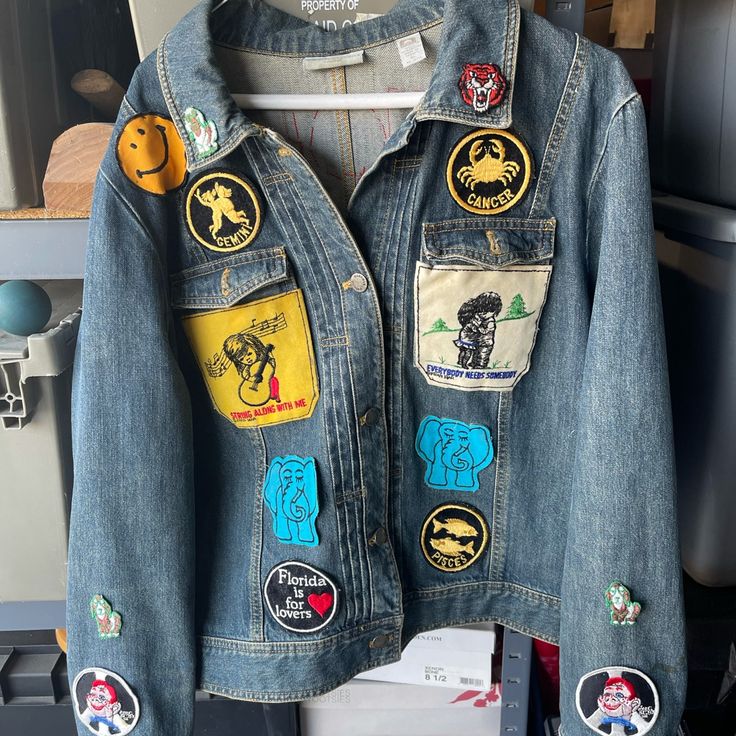 Selling A Vintage Valerie Stevens Denim Jacket I Believe It’s From The 70’s With Some Vintage Sewn Patches On Front Of Jacket Also On The Back And A Couple On The Sleeves. Minor Stain On Left Sleeve That Can Be Washed Away. Denim Jacket With Patches And Long Sleeves, Denim Jacket With Patches Long Sleeve, Retro Denim Patchwork Outerwear, Casual Patchwork Denim Jacket, Dark Wash Long Sleeve Denim Jacket With Patches, Dark Wash Denim Jacket With Patches, Denim Outerwear With Patches And Long Sleeves, Retro Outerwear With Embroidered Patch For Spring, Retro Spring Outerwear With Embroidered Patch