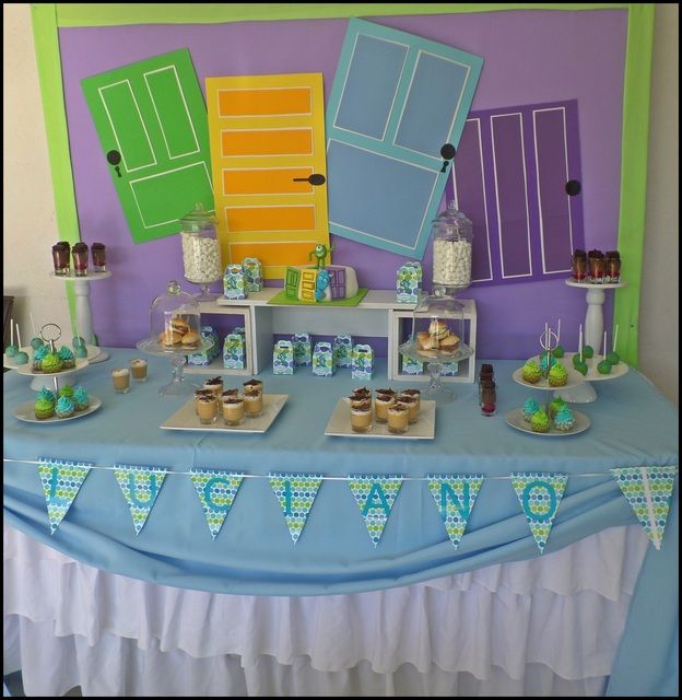 a blue table topped with cakes and cupcakes