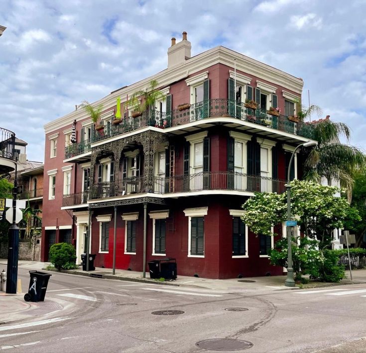 an apartment building with balconies and balconyes on the second floor is painted red