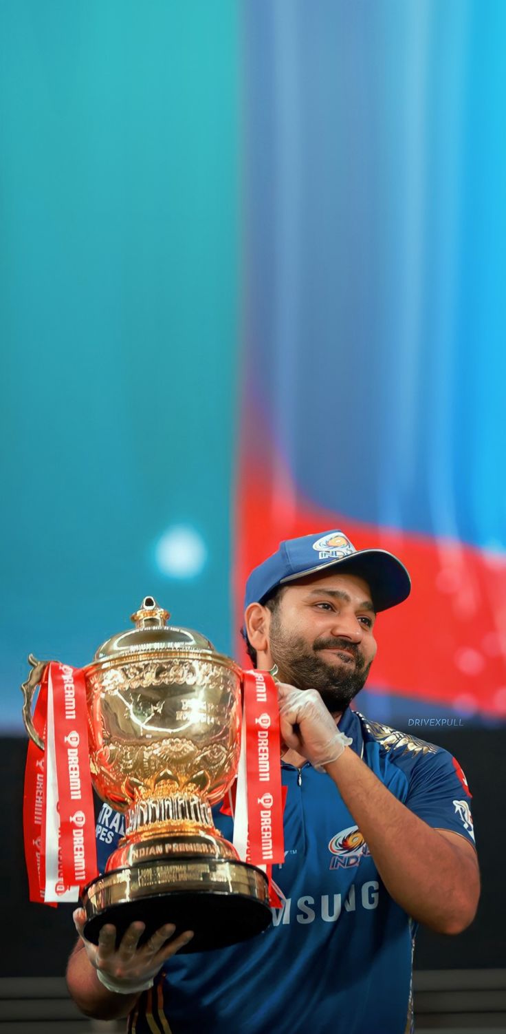 a man holding up a trophy on top of a tennis court