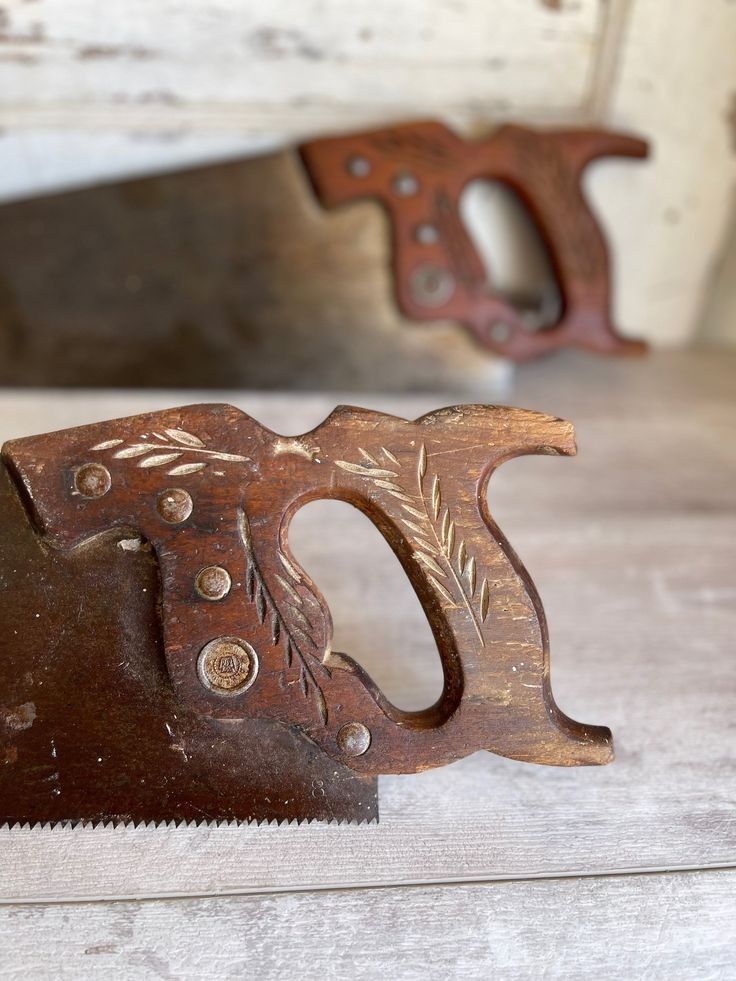 an old pair of scissors sitting on top of a wooden table