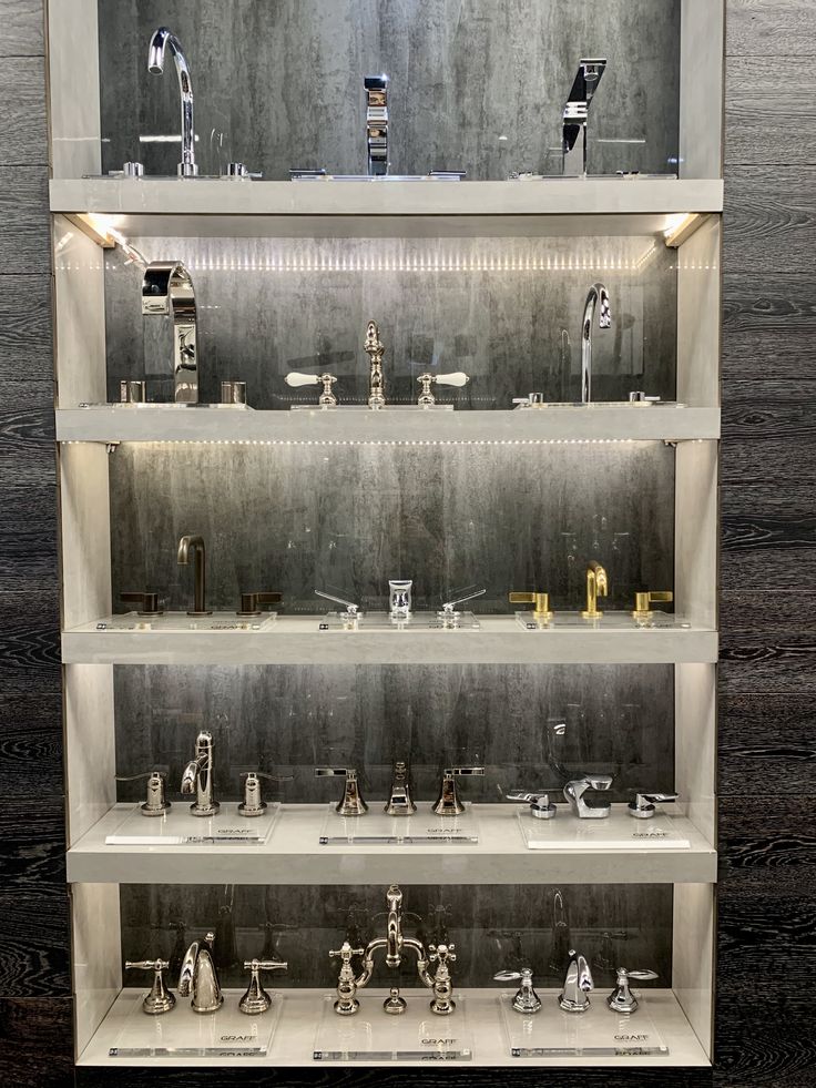 the shelves are filled with different types of faucets and sink basins on display