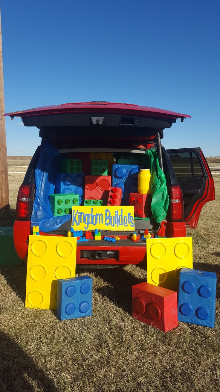 the back end of a red van with lego blocks on it's tailgate