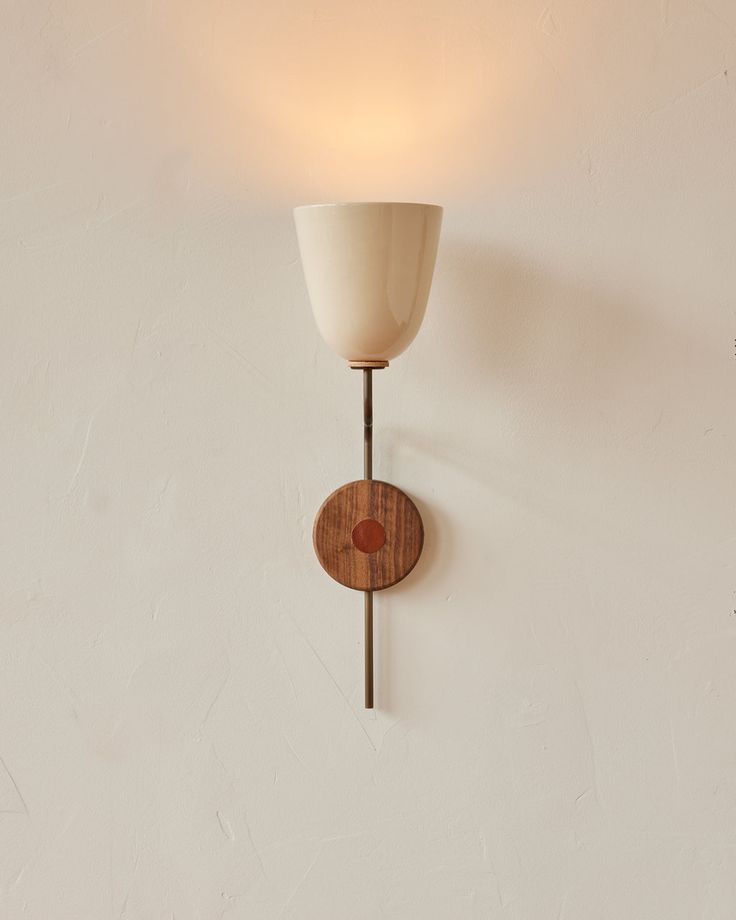 a wooden light fixture mounted to the side of a wall