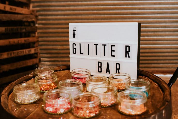 there is a sign that says glitter r bar on top of some jars