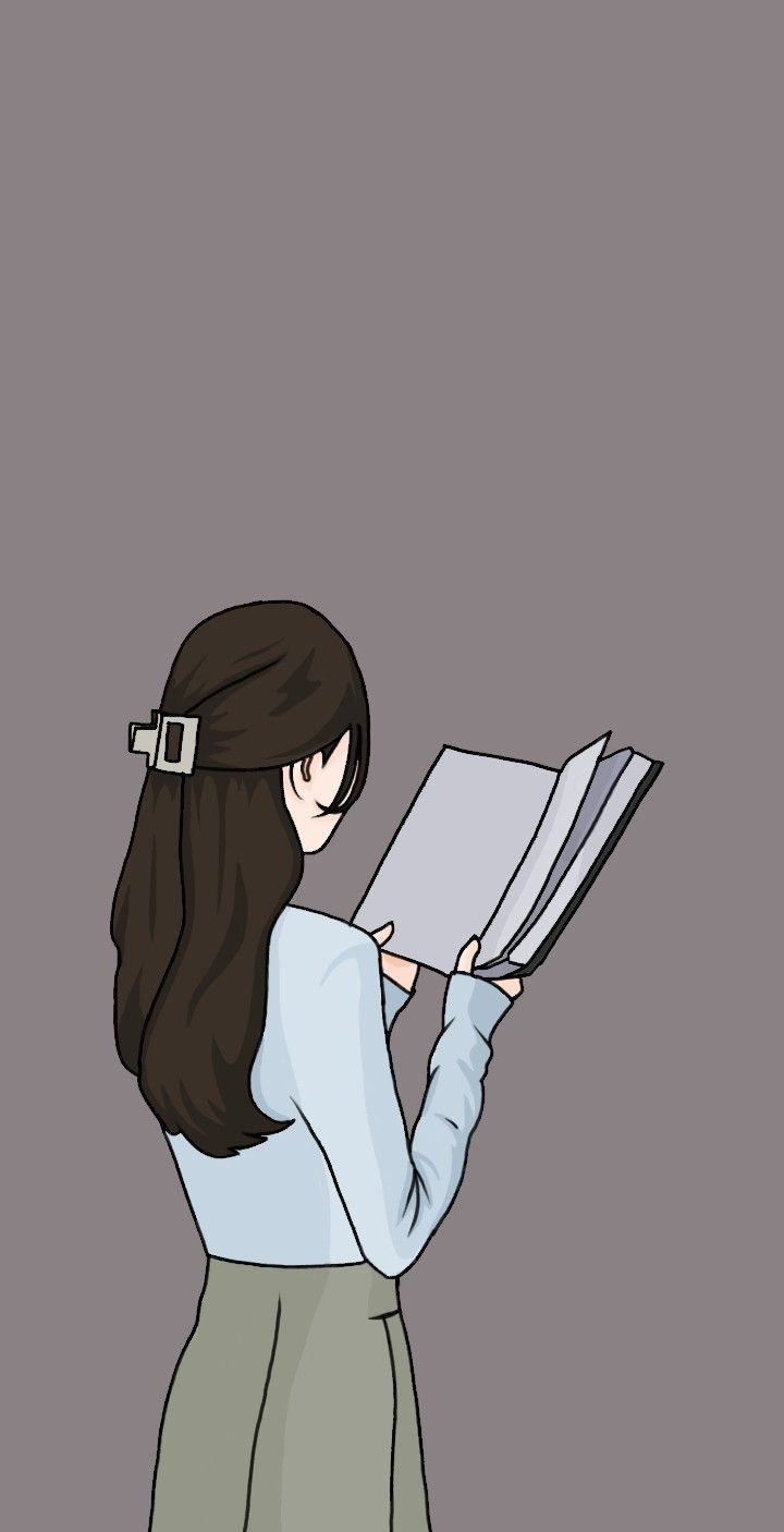 a woman reading a book while standing in front of a gray background