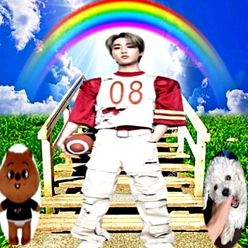 a man standing in front of a rainbow with two dogs and a teddy bear next to him