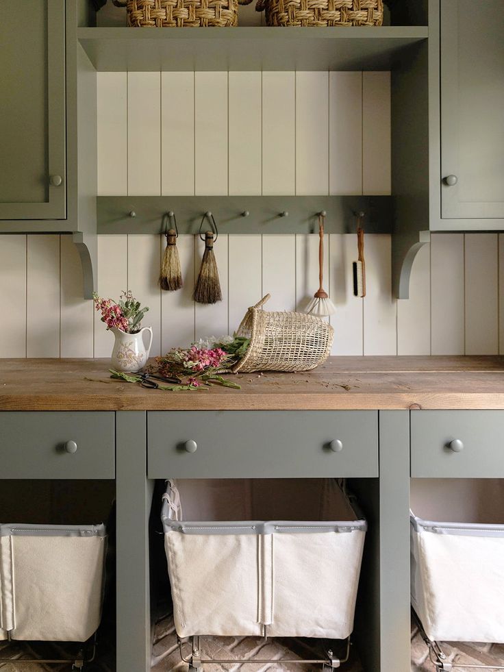 the kitchen counter is covered with linens and utensils, along with baskets