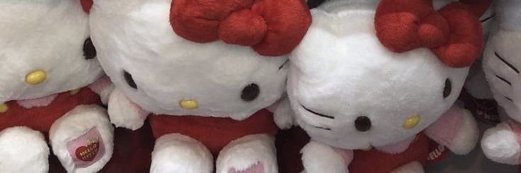 several hello kitty stuffed animals are on display