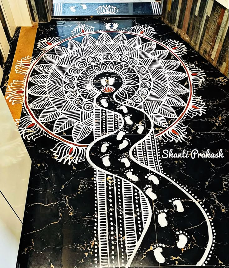 a black and white floor with an intricate design on it