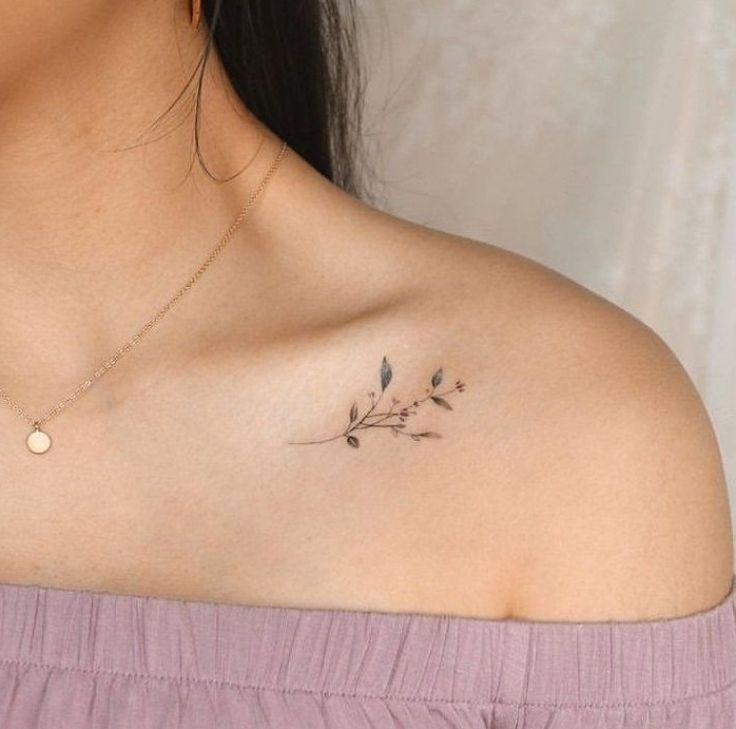 a woman with a small tattoo on her shoulder