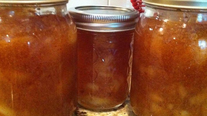 three jars filled with food sitting on top of a counter