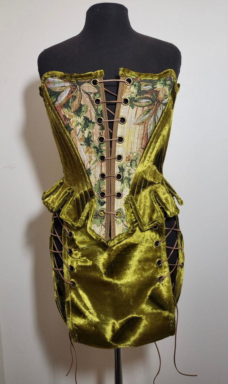 "Available now  Handmade 18th Century style moss green fairy inspired corset with matching skirt.  Made with sustainable and recycled fabrics.  Laced at front and back with camel faux suede lace.  Fully boned front with plastic boning. Sizing:  Waist: 24\"- 29\"  Bust: 30\" - 36\" Skirt fits Hips: 32\" - 35\" Length 13\" Model is 26\" waist, 32\" bust and 32\" hips for reference" Custom Corsets, Handmade Fairy, Green Fairy, Womens Blouses, Skirt Fits, Suede Lace, Gifts For My Sister, Moss Green, Corsets