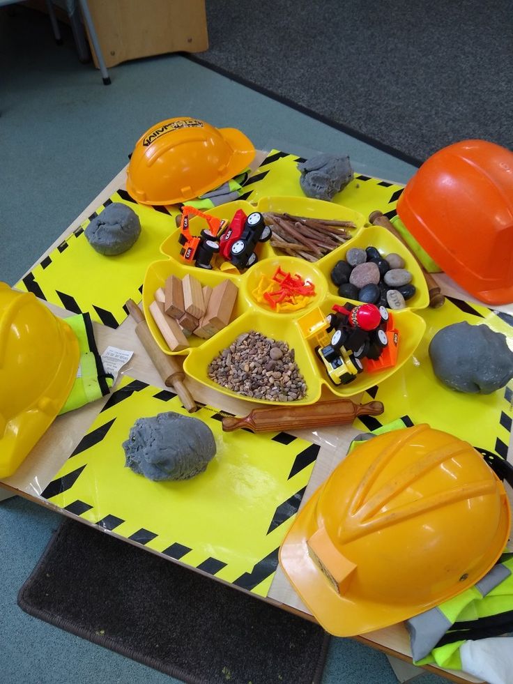 construction themed table with hard hats and other items