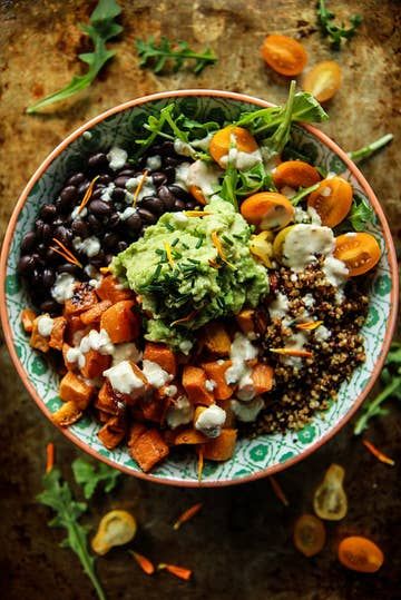 a bowl filled with lots of food on top of a table