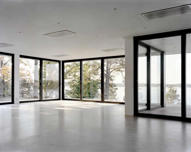 an empty room with large windows and doors