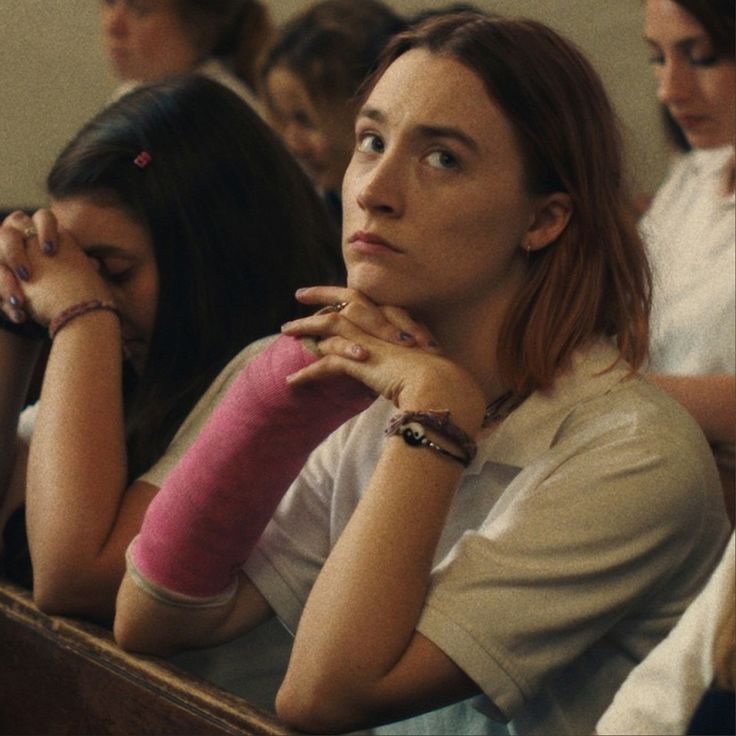 two women sitting next to each other with their hands on their chins in front of them