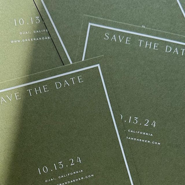 four green save the dates cards on top of each other