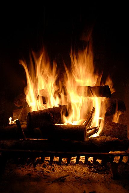 a fire burning in a fireplace with bright flames