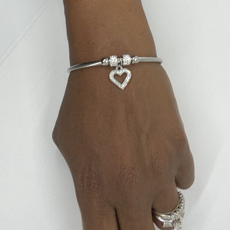 Product Details - Stainless steel with cubic zirconia heart charm - Fits wrists up to 7.5 inches Bracelet Stacks, Bracelet With Heart, Basic Girl, Silver Heart Bracelet, Silver Jewelry Box, Stainless Steel Bangles, Cute Bikinis, Heart Bracelet, Bracelet Stack