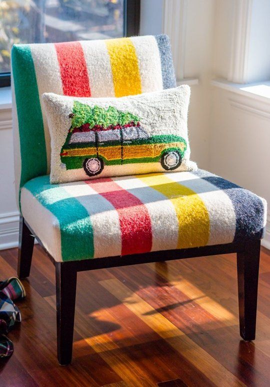 a colorful striped chair with a pillow on it