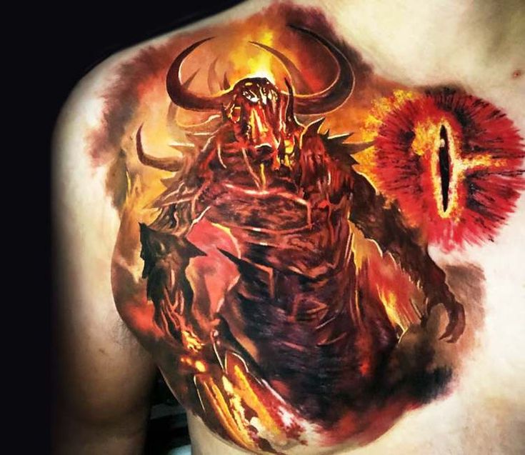 a man with a tattoo on his chest that is covered in fire and demon artwork