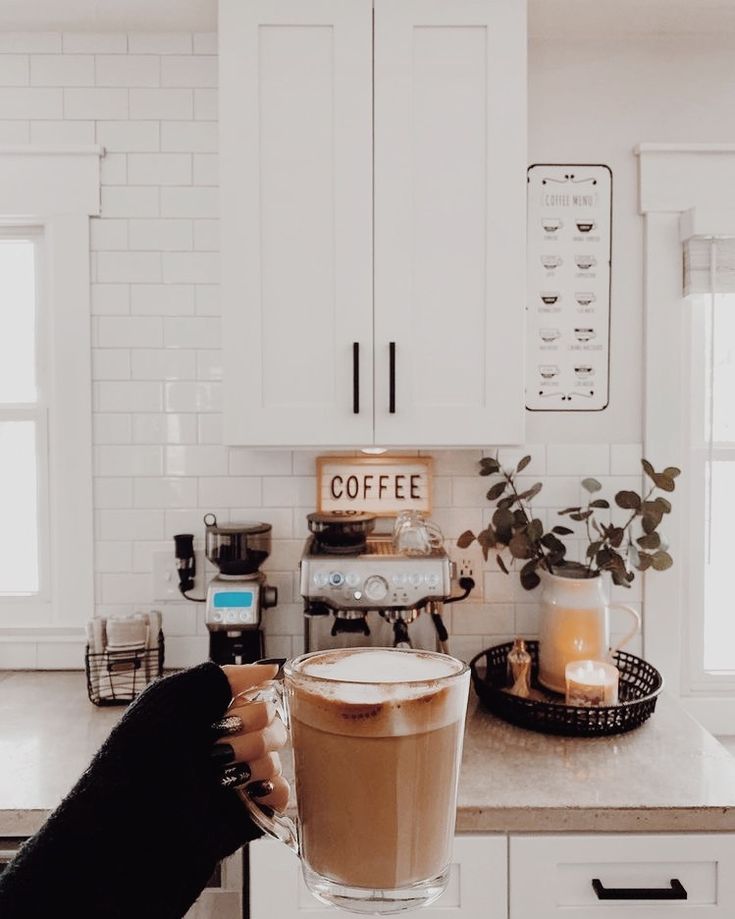 a person is holding a cup of coffee