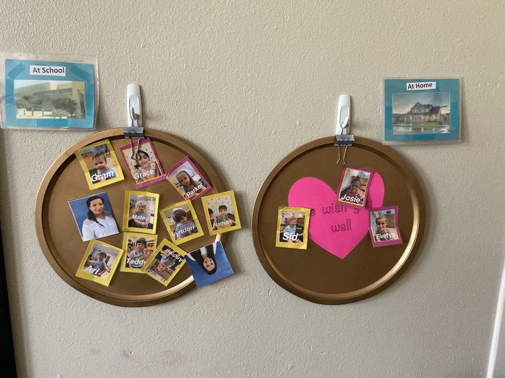 there are two pictures on the wall with magnets attached to them and one has a heart