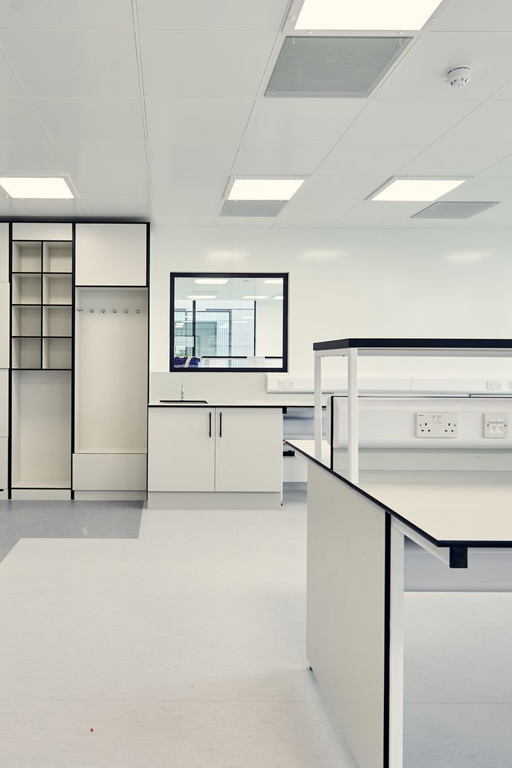 an empty office with white cabinets and counters