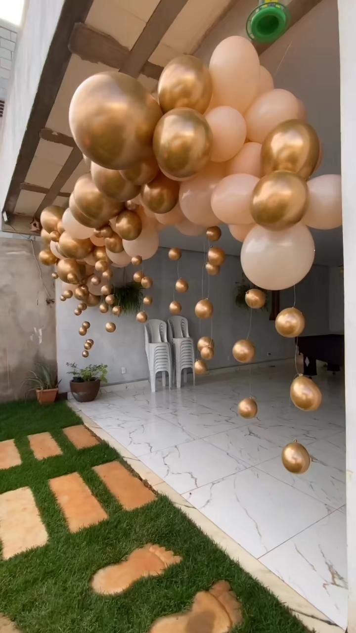 some balloons are hanging from the ceiling outside