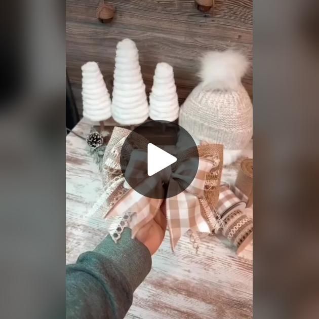 a person is holding out their hand to some knitted hats on a wooden table